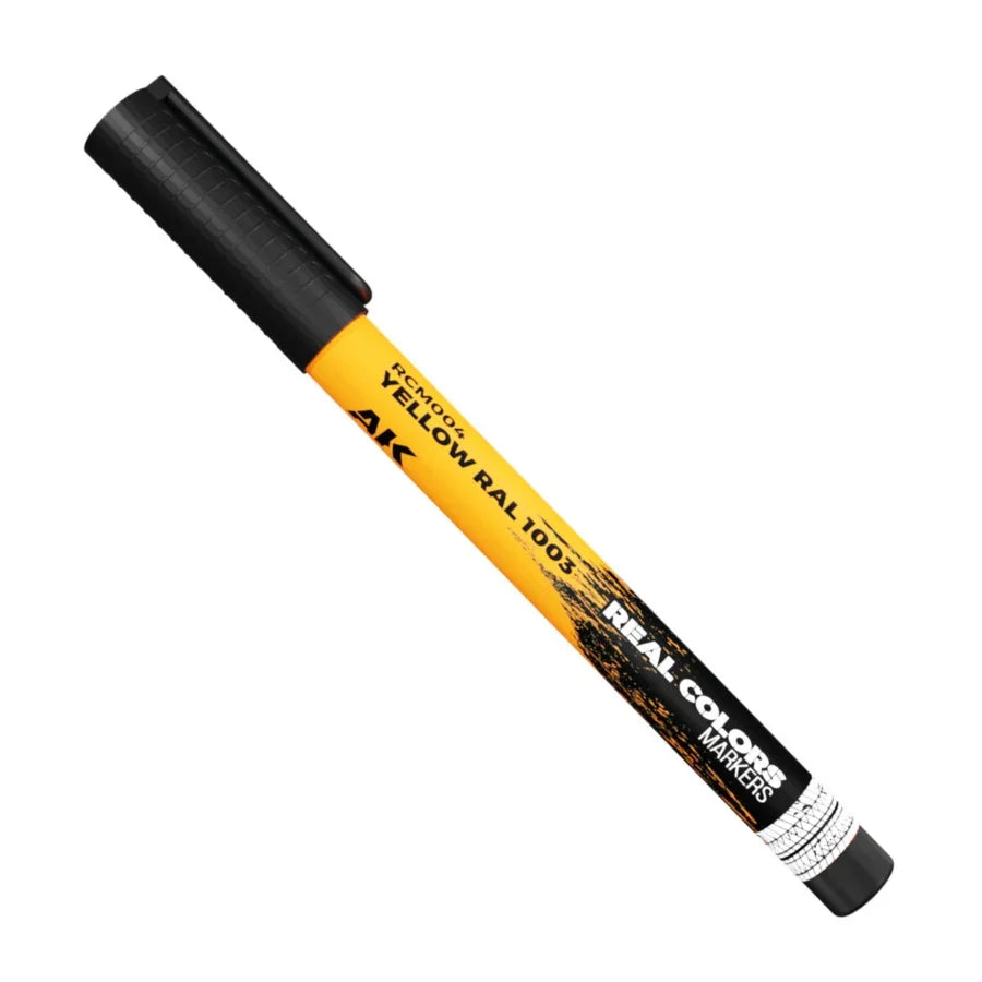 Close-up of AK Interactive Real Colors Marker Yellow RAL 1003 acrylic paint marker for scale modelling and hobby use.