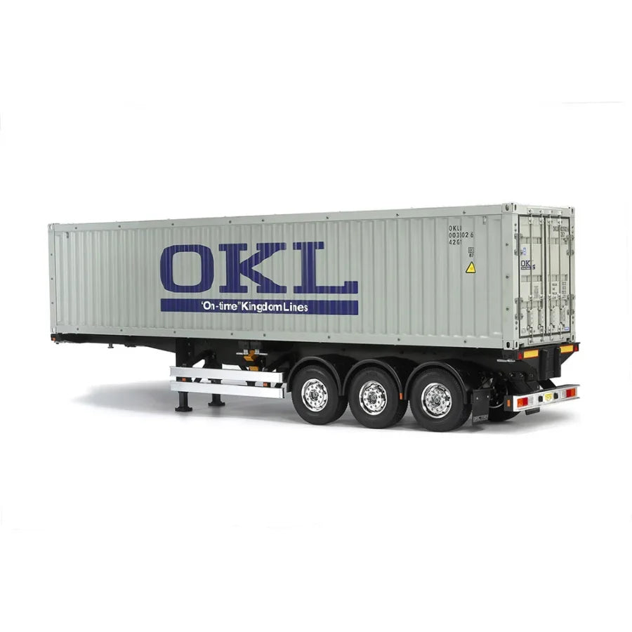 Tamiya 1:14 40-foot ISO container mounted on a three‑axle semi‑trailer chassis kit showing detailed side panels and twist-locks