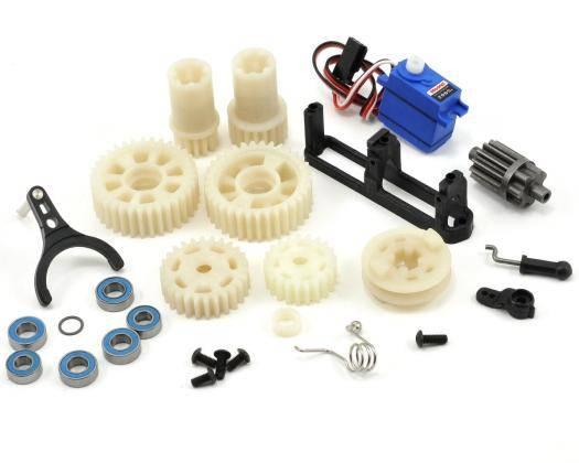 RC car gear set with plastic gears, bearings, servo, and metal parts for model assembly