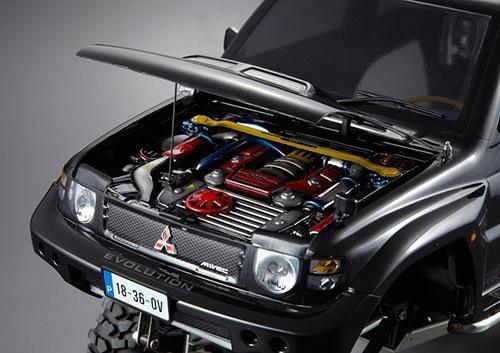 Detailed Mitsubishi Lancer Evolution model car with open hood showing engine, collectible hobby kit