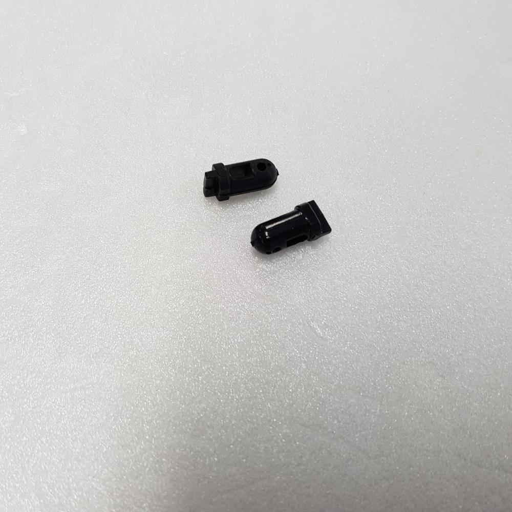 Black plastic model kit parts for hobby assembly on white foam background