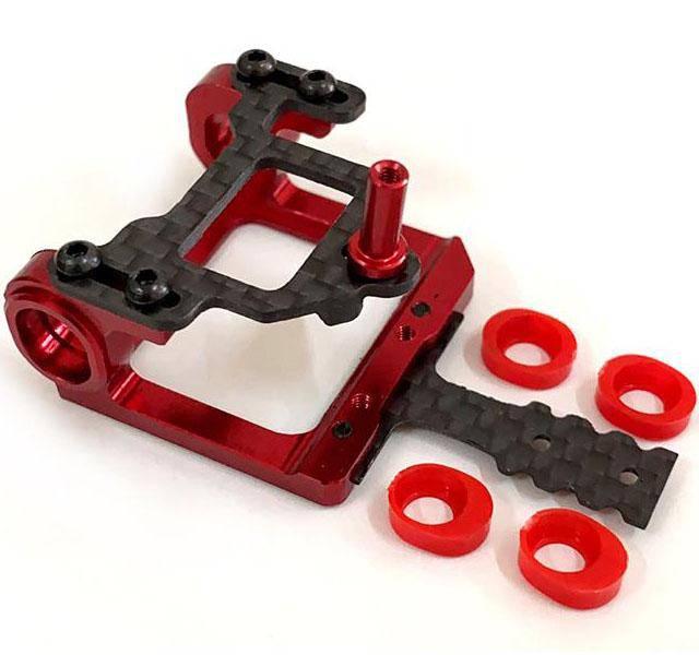 Red and black RC car chassis with carbon fiber parts and red shock mounts for model building