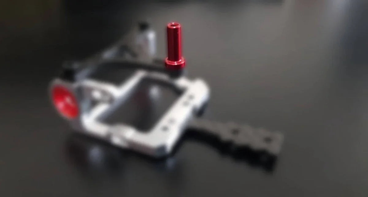 Red anodized aluminum upgrade part for RC car chassis, precision-engineered for hobbyists