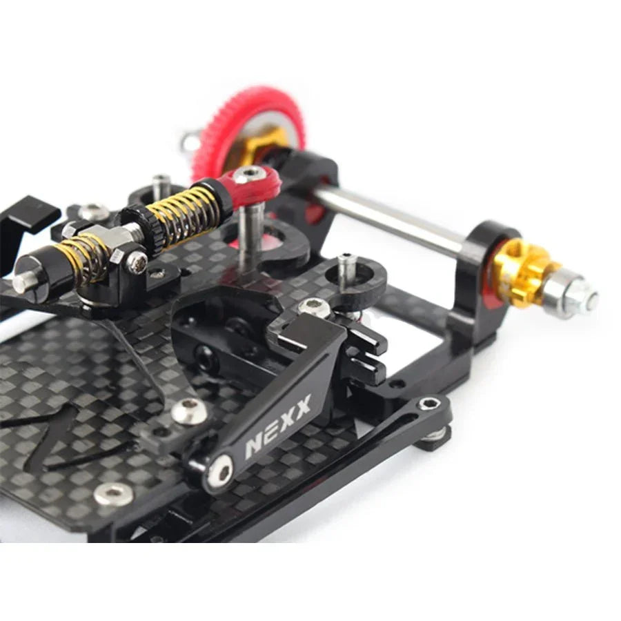 Carbon fiber RC car chassis kit with NEXX branding, visible gears and suspension parts.
