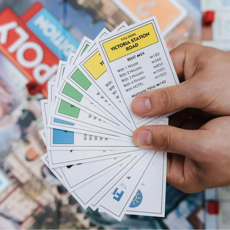 Assorted board games for kids, families, and adults displayed on a wooden table for game night