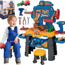 Child in overalls sitting on a toy workbench with tools and machinery