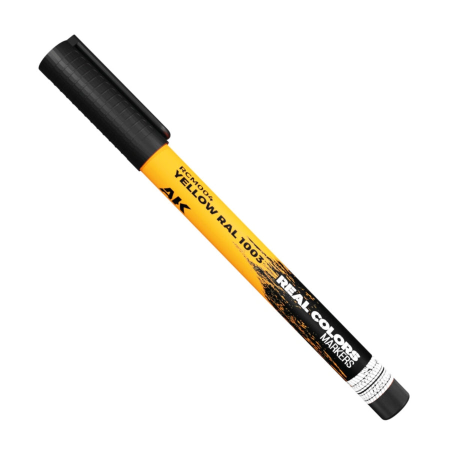 Close-up of AK Interactive Real Colors Marker Yellow RAL 1003 acrylic paint marker for scale modelling and hobby use.