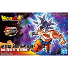 Photo of Bandai Figure‑Rise Standard Son Goku (Ultra Instinct) model kit showing silver‑haired Goku, muscular torso, and action pose parts.