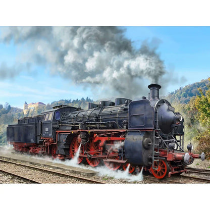 Detailed model steam locomotive with red wheels on railway track, scenic countryside background