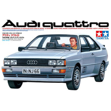 Tamiya 1:24 Audi Quattro plastic model kit box and sprue detail, showing turbo engine, rubber tyres, clear parts and decal sheet
