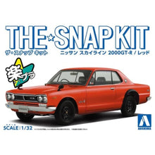 Aoshima 1/32 snap-fit model kit of the Nissan Skyline 2000 GTR in red, featuring detailed bodywork, realistic wheels, and authentic interior design.